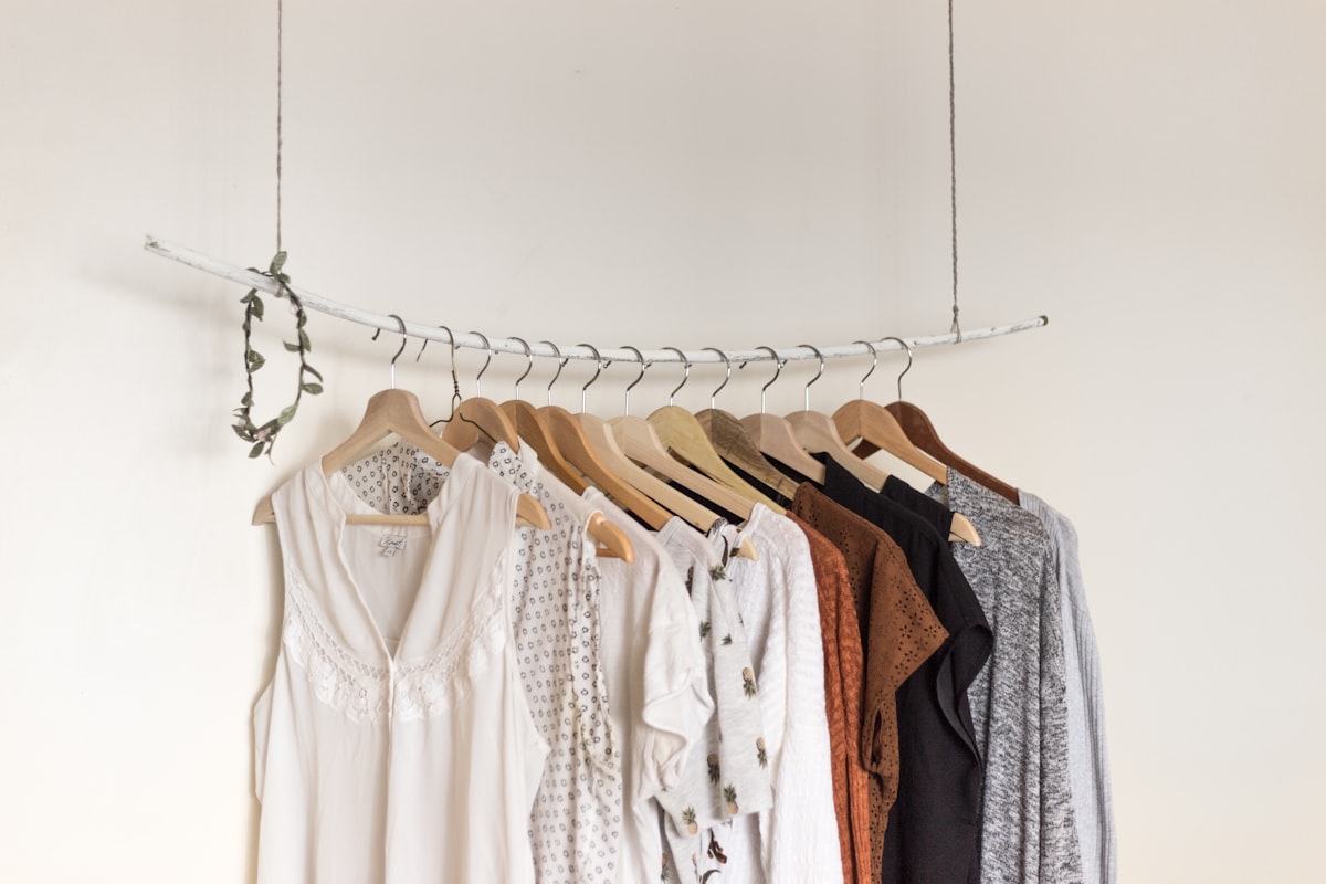 Neutral capsule wardrobe pieces folded and arranged for outfit planning